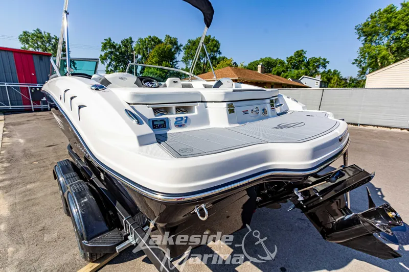 Slide: The Image of 2025 Chaparral 21 SSi Ski & Fish boat on trailer at marina. - 4