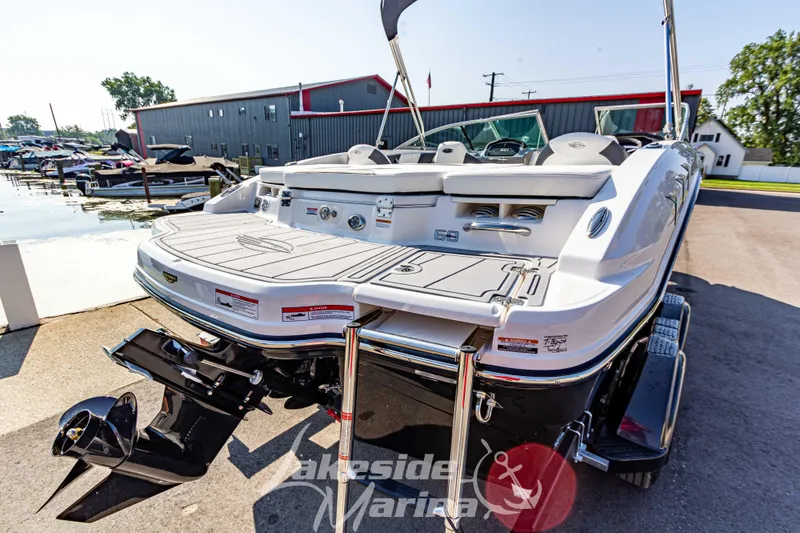 Slide: The Image of 2025 Chaparral 21 SSi Ski & Fish boat at marina, rear view with swim platform. - 6