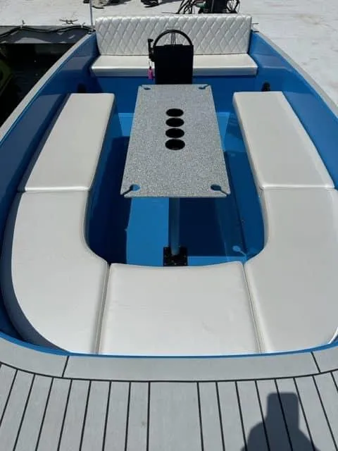 Slide: The Image of 2023 Vision Marine Technologies Volt 180 boat interior with white seating and central table. - 2