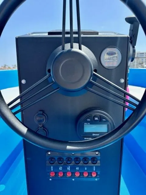 Slide: The Image of 2023 Vision Marine Technologies Volt 180 steering console with controls and gauges. - 4