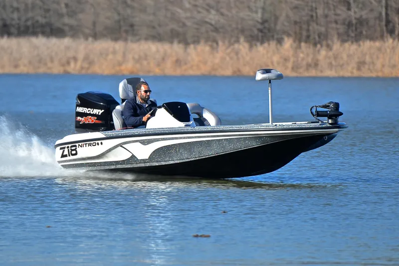 The Image of 2018 Nitro Z18 Pro boat speeding on a lake with a Mercury engine. - 1
