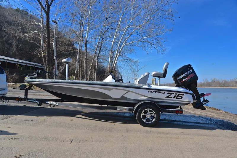 Slide: The Image of 2018 Nitro Z18 Pro boat on trailer by a lakeside, clear blue sky. - 11