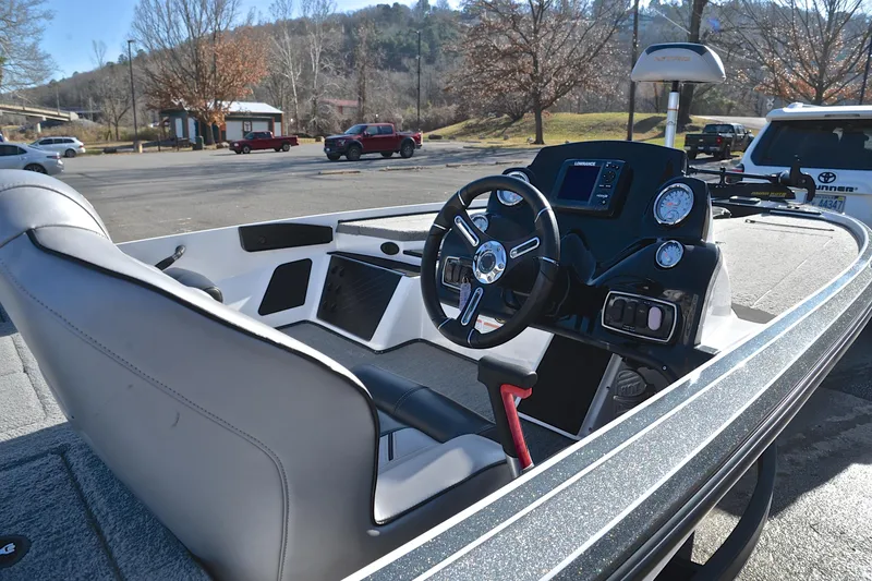 Slide: The Image of 2018 Nitro Z18 Pro boat interior with steering wheel and dashboard in a parking lot. - 19