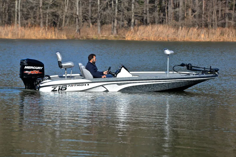Slide: The Image of Man driving 2018 Nitro Z18 Pro boat on a calm lake. - 7