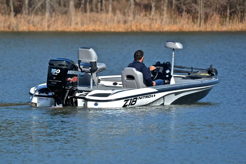 Slide: The Image of Man driving a 2018 Nitro Z18 Pro boat on a calm lake. - 8