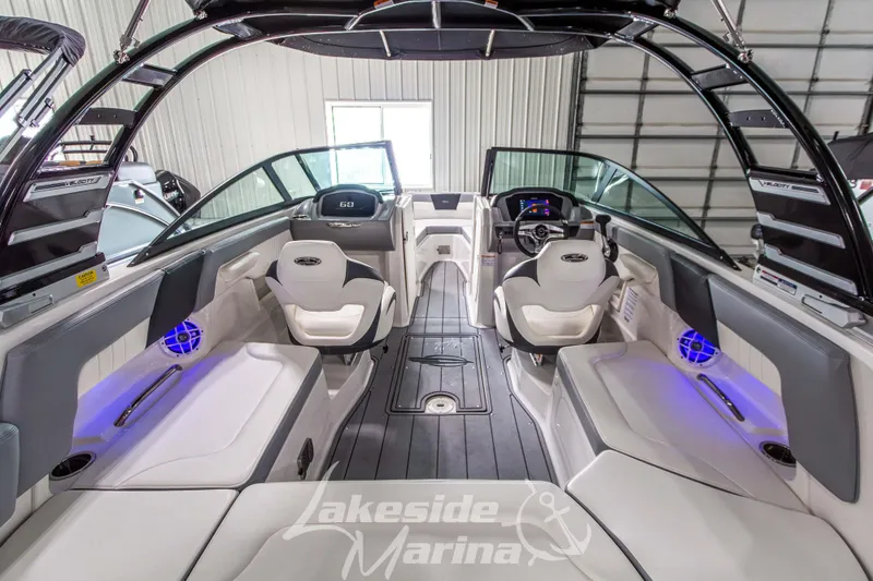 Slide: The Image of 2025 Chaparral 23 SSi boat interior with modern seating and ambient lighting. - 12