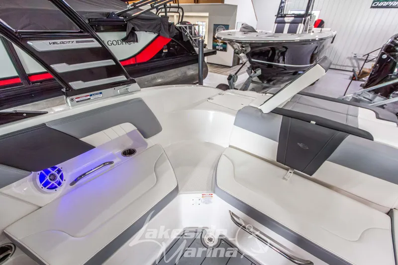 Slide: The Image of 2025 Chaparral 23 SSi boat interior with modern seating and blue LED lighting. - 16