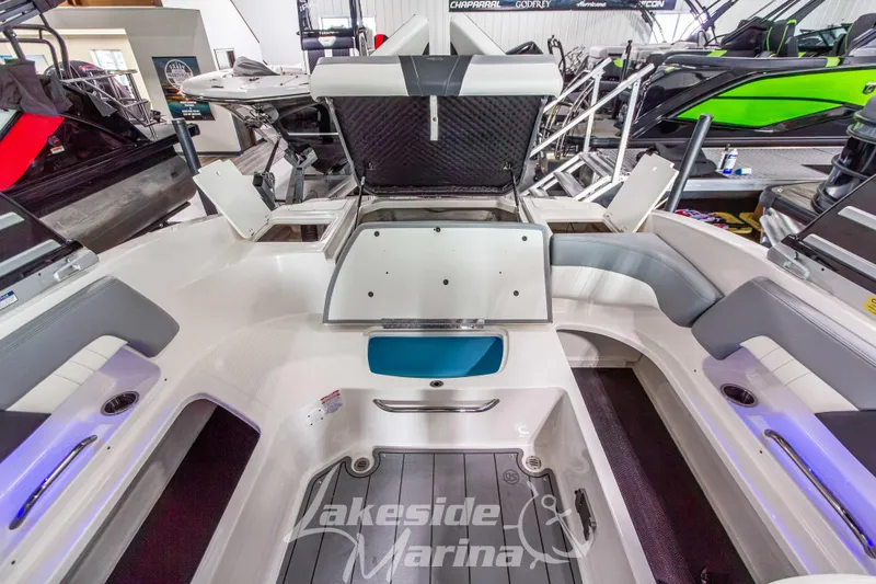 Slide: The Image of 2025 Chaparral 23 SSi boat interior with open storage compartments at Lakeside Marina. - 17