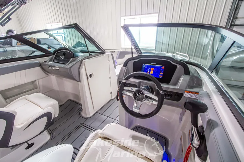 Slide: The Image of 2025 Chaparral 23 SSi boat interior with modern dashboard and steering wheel. - 20
