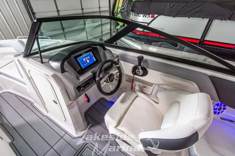 Slide: The Image of 2025 Chaparral 23 SSi boat interior with modern dashboard and steering wheel. - 21