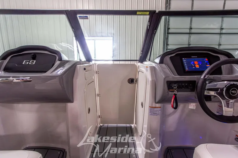 Slide: The Image of 2025 Chaparral 23 SSi boat interior with modern dashboard and steering wheel. - 25