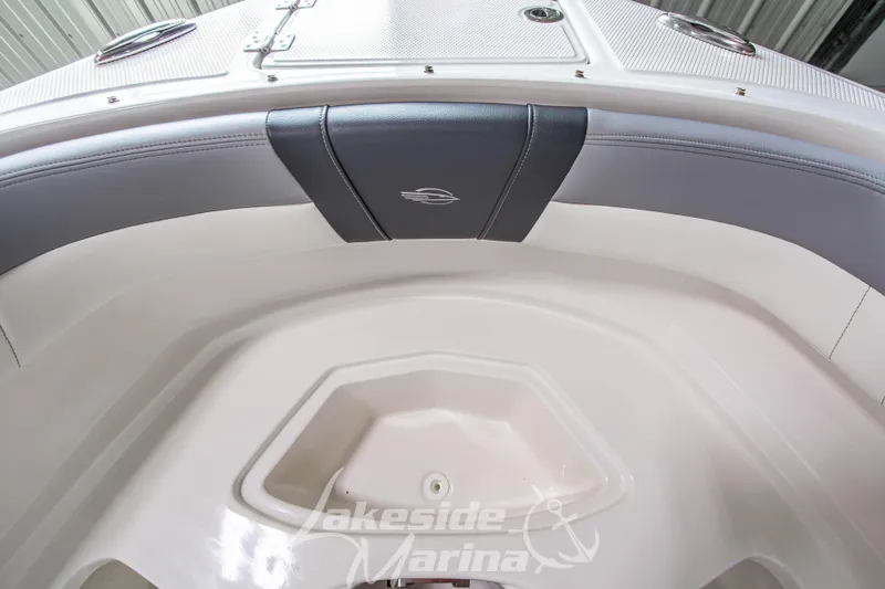 Slide: The Image of 2025 Chaparral 23 SSi boat interior with cushioned seating and storage compartment. - 32