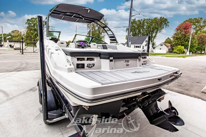Slide: The Image of 2025 Chaparral 23 SSi boat at Lakeside Marina, rear view with outboard motor. - 6