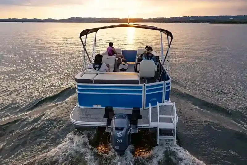 Slide: The Image of Manufacturer Provided Image: 2026 SunCatcher Select 20C pontoon boat cruising at sunset on a serene lake. - 10