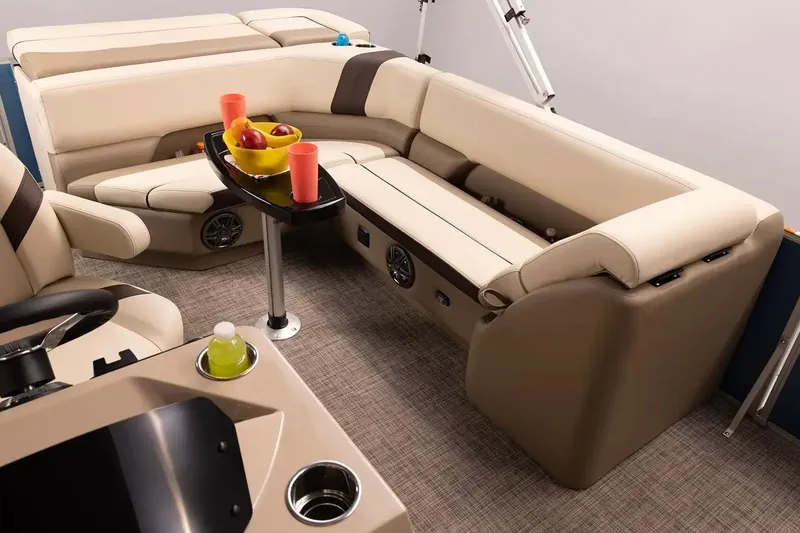Slide: The Image of Manufacturer Provided Image: Luxurious interior of 2026 SunCatcher Select 20C pontoon boat with plush seating and table. - 13