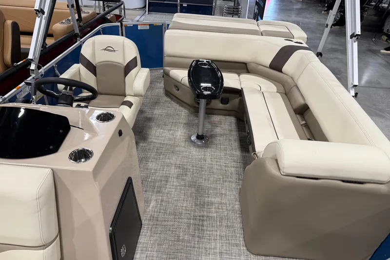 Slide: The Image of 2026 SunCatcher Select 20C pontoon boat interior with beige seating and steering console. - 5
