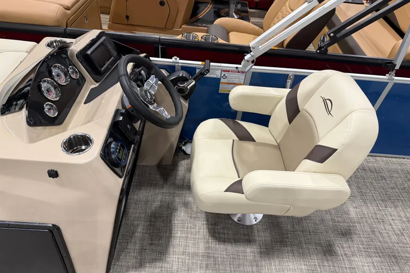 Slide: The Image of 2026 SunCatcher Select 20C boat interior with steering console and plush captain's chair. - 6