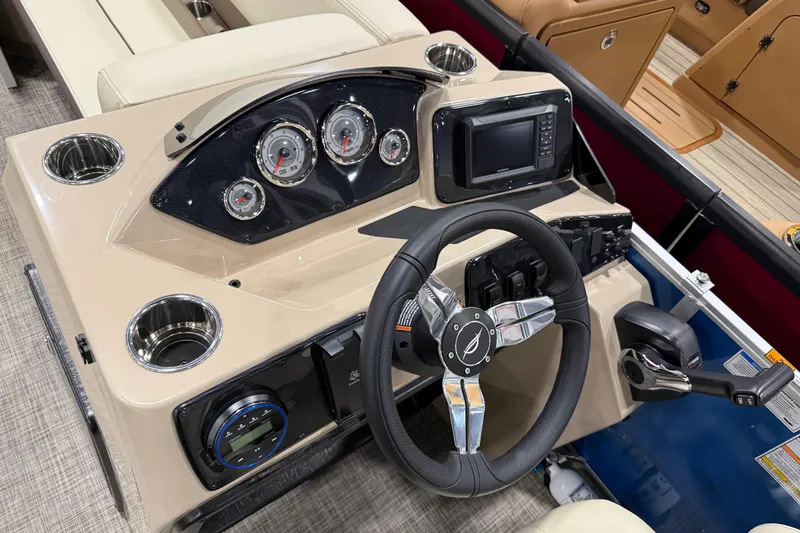 Slide: The Image of 2026 SunCatcher Select 20C boat dashboard with steering wheel, gauges, and controls. - 9