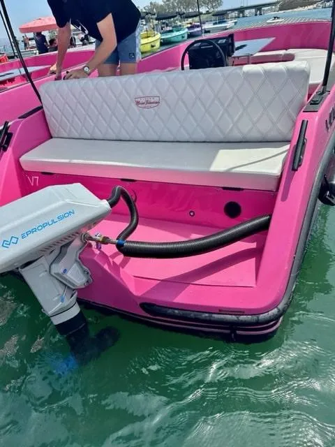 Slide: The Image of 2023 Vision Marine Technologies Volt 180, pink boat with ePropulsion motor, docked on water. - 4