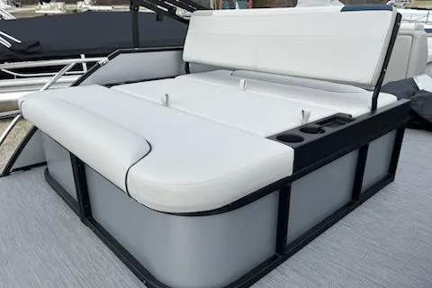 Slide: The Image of 2026 Sweetwater 2286SFLC boat with white cushioned seating and cup holders. - 11