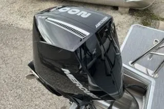 Slide: The Image of Mercury outboard motor on Sweetwater 2286SFLC, 2026 model, parked on concrete surface. - 13