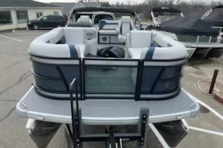 Slide: The Image of 2026 Sweetwater 2286SFLC pontoon boat, rear view, in a marina setting. - 14