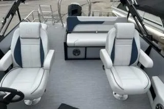 Slide: The Image of 2026 Sweetwater 2286SFLC boat interior with white and blue seating, modern design. - 17