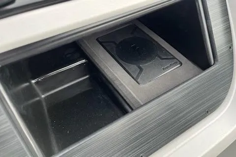 Slide: The Image of Storage compartment in 2026 Sweetwater 2286SFLC boat with wireless charging pad. - 2