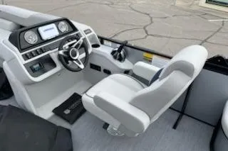 Slide: The Image of 2026 Sweetwater 2286SFLC boat interior with modern dashboard and comfortable seating. - 20