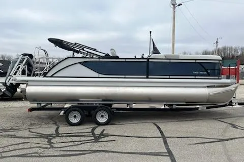 Slide: The Image of 2026 Sweetwater 2286SFLC pontoon boat on trailer in parking lot. - 24