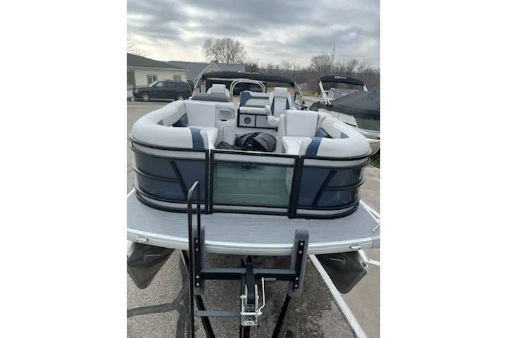 Slide: The Image of 2026 Sweetwater 2286SFLC pontoon boat with spacious seating, parked outdoors. - 29