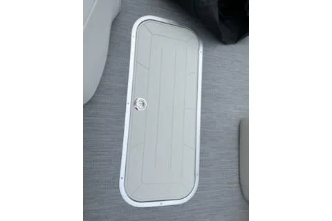 Slide: The Image of 2026 Sweetwater 2286SFLC boat hatch on gray deck flooring. - 3