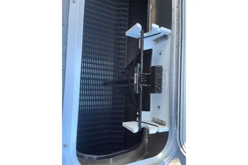 Slide: The Image of Interior view of 2026 Sweetwater 2286SFLC boat compartment with black grid and white supports. - 5
