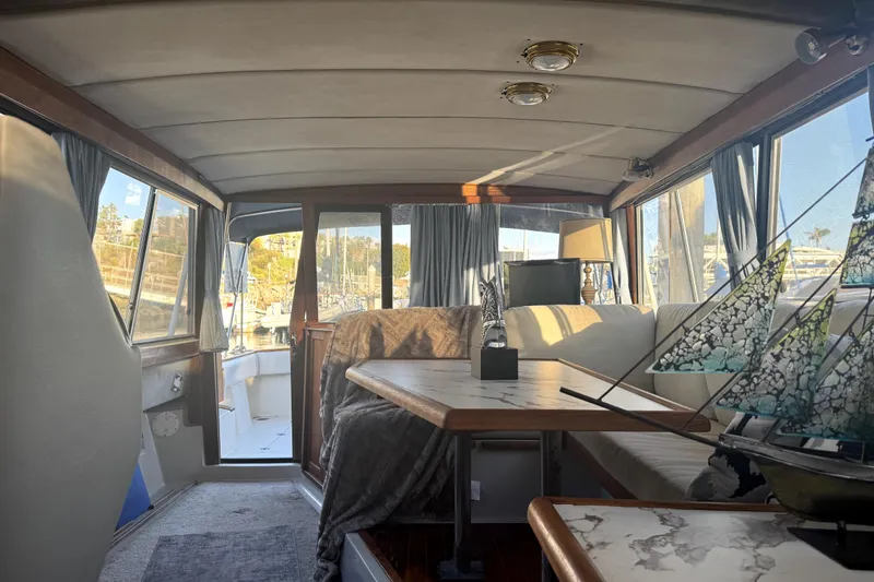 Slide: The Image of Interior of 1987 Bayliner 3270 Motoryacht with cozy seating and nautical decor. - 17