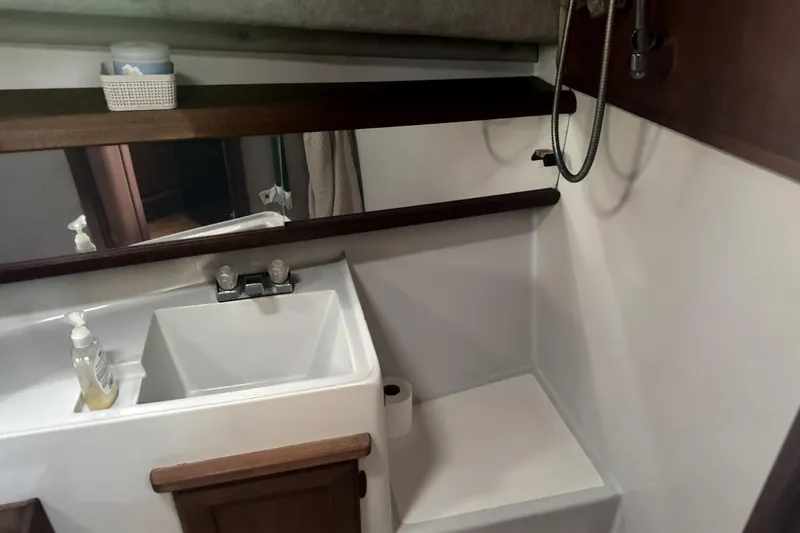 Slide: The Image of 1987 Bayliner 3270 Motoryacht bathroom with sink, mirror, and shower area. - 38