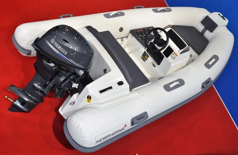 Slide: The Image of 2021 Northstar Axis 3.1 inflatable boat with Yamaha outboard motor on red display. - 11
