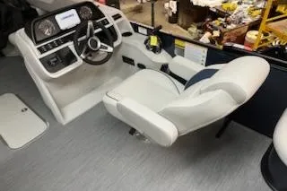 Slide: The Image of Captain's seat and helm of 2026 Sweetwater 2286SFL boat, featuring modern controls and steering. - 10