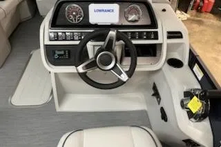 Slide: The Image of 2026 Sweetwater 2286SFL boat dashboard with steering wheel and navigation display. - 11