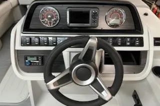 Slide: The Image of Steering console of 2026 Sweetwater 2286SFL boat with modern gauges and controls. - 13