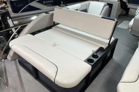 Slide: The Image of 2026 Sweetwater 2286SFL boat interior with white seating and cup holders. - 6