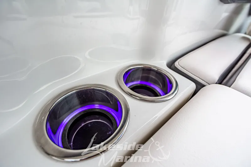 Slide: The Image of 2025 Chaparral 247 SSX boat cup holders with purple LED lighting. - 17