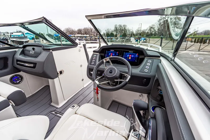 Slide: The Image of 2025 Chaparral 247 SSX boat interior with modern dashboard and steering wheel. - 18