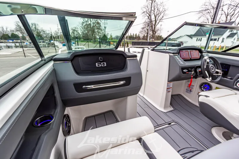 Slide: The Image of Interior view of 2025 Chaparral 247 SSX boat with modern dashboard and seating. - 24