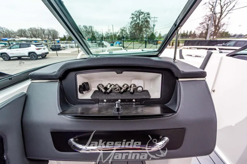 Slide: The Image of 2025 Chaparral 247 SSX dashboard with sleek controls at Lakeside Marina. - 26