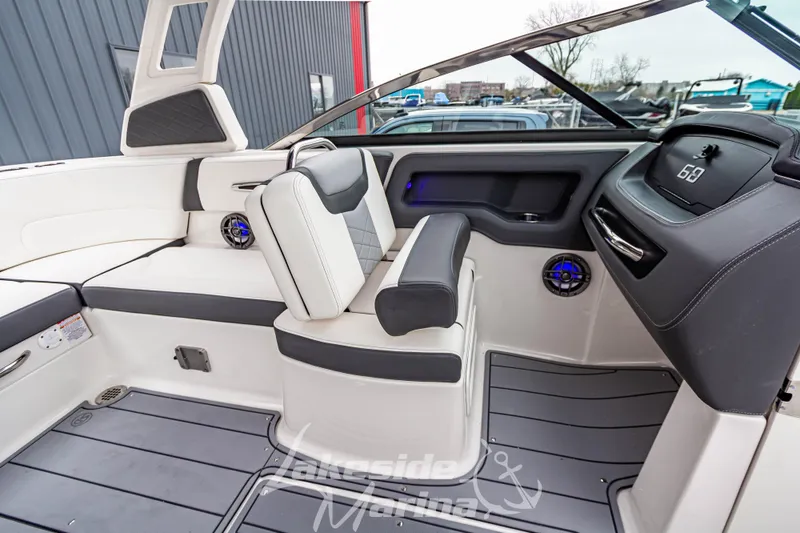 Slide: The Image of 2025 Chaparral 247 SSX boat interior with modern seating and dashboard design. - 28