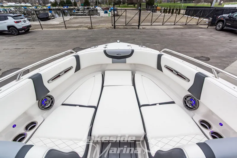 Slide: The Image of 2025 Chaparral 247 SSX boat interior with white seating and modern design at Lakeside Marina. - 35