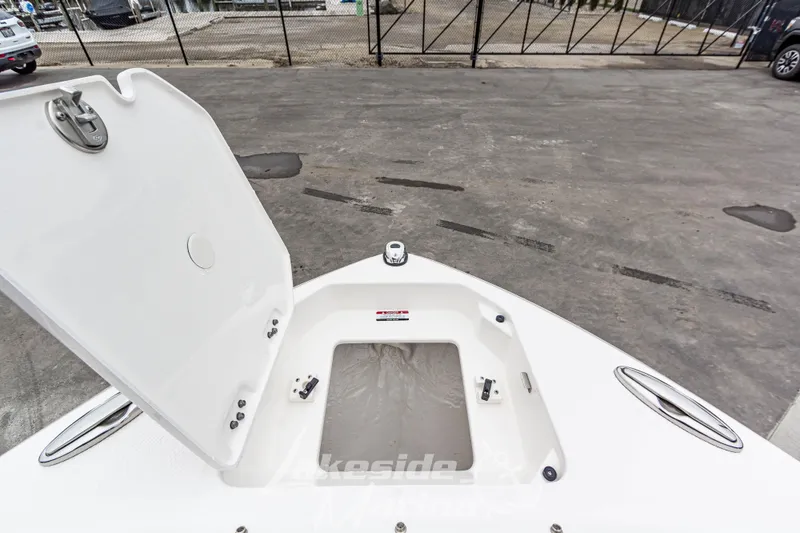 Slide: The Image of Open storage compartment on 2025 Chaparral 247 SSX boat, dockside view. - 39