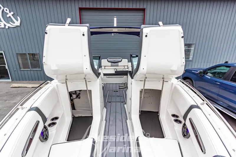 Slide: The Image of 2025 Chaparral 247 SSX boat interior with open storage compartments and seating. - 40