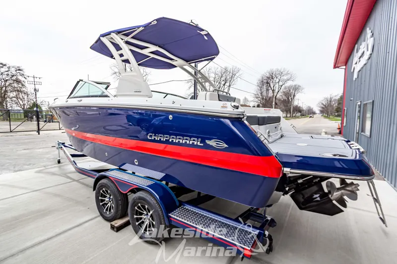 Slide: The Image of 2025 Chaparral 247 SSX boat in blue and red, parked at Lakeside Marina. - 7