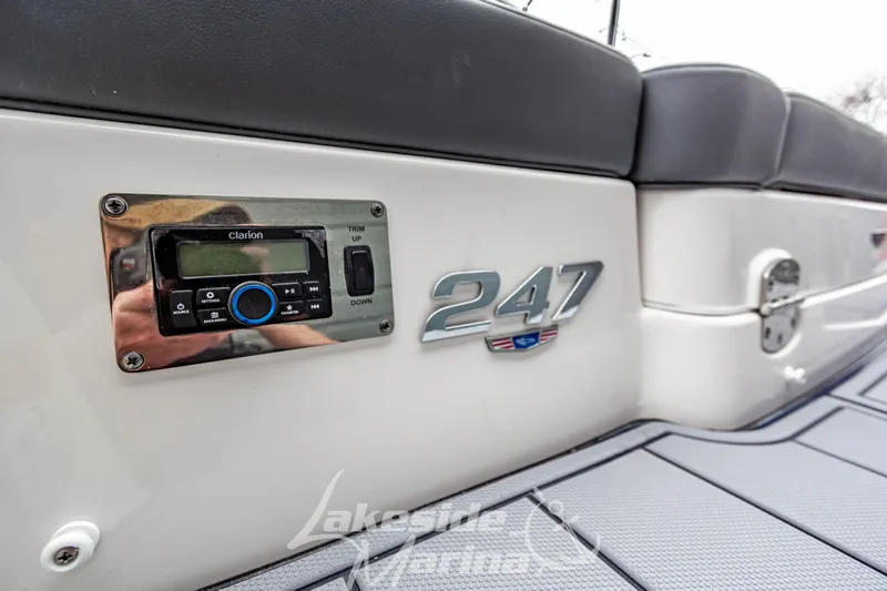 Slide: The Image of 2025 Chaparral 247 SSX boat interior with Clarion audio system and logo. - 9